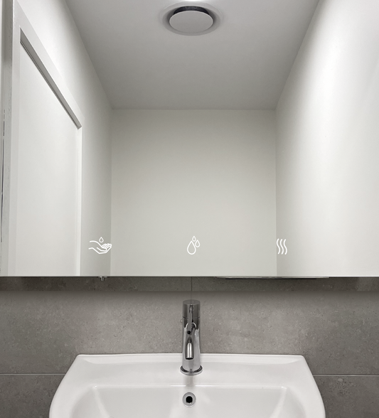 Behind the mirror hand dryer and electric soap dispenser. Mirror vanity